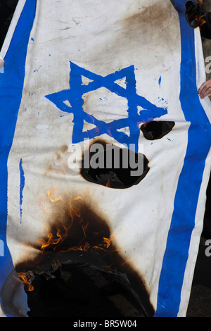 I membri dell'Ultra ebrea ortodossa anti-sionista, il gruppo Neturei Karta, bruciare la bandiera israeliana. Stamford Hill. Foto Stock