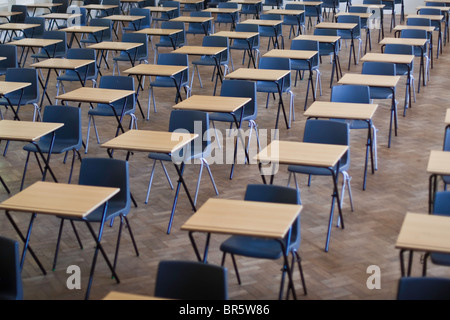 Scrivanie e sedie stabiliti per gli esami in una scuola hall nel Regno Unito. Foto Stock