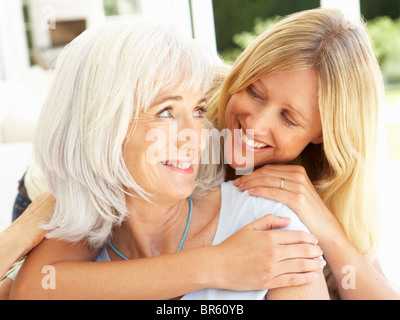 Ritratto di Madre e figlia adulta rilassante sul divano Foto Stock