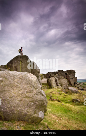 Un escursionista sul bordo Curbar nel Parco Nazionale di Peak District, Derbyshire, England, Regno Unito Foto Stock
