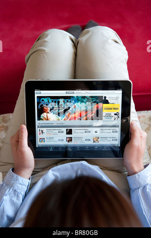 Donna che utilizza computer tablet iPad per navigare online digitale iTunes Music Store Foto Stock