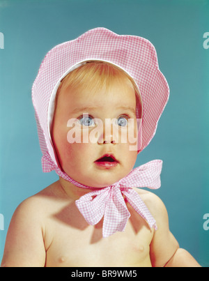 Anni sessanta molto carino biondo dagli occhi blu BABY indossando rosso bianco controllato HAT legato in prua al mento Foto Stock