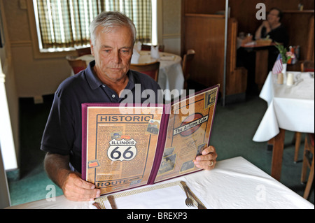 L'uomo guarda nel menu storico Cafe Ariston lungo la Route 66 Litchfield Illinois Foto Stock