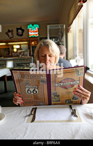 Donna guarda al menu nella storica Ariston Cafe lungo la Route 66 Litchfield Illinois Foto Stock