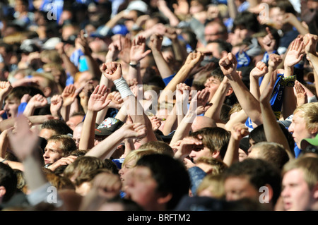 I fan del club calcistico tedesco Schalke 04 alza le mani in aria Foto Stock