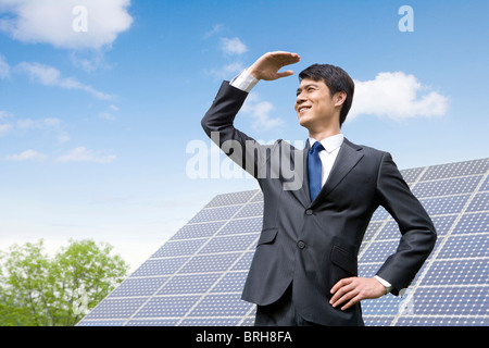 Ritratto di un uomo di affari di fronte a pannelli solari Foto Stock