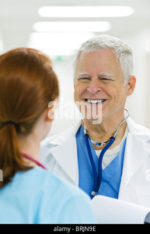 Medico di parlare a un infermiere Foto Stock