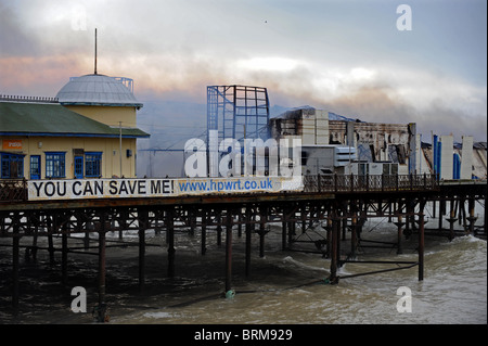 Hastings Pier smolders dopo un incendio doloso nelle prime ore di questa mattina lo lascia quasi completamente distrutta Foto Stock