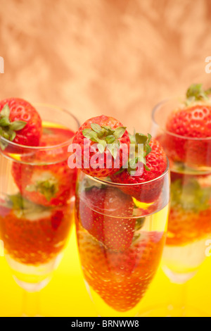 Champagne flauti contenenti champagne e fragole, close-up Foto Stock