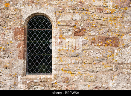 Close up tradizionale a piombo ad arco la finestra della chiesa nel muro di pietra England Regno Unito Foto Stock