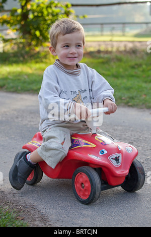 Ritratto di un ragazzino sul suo bobby car Foto Stock
