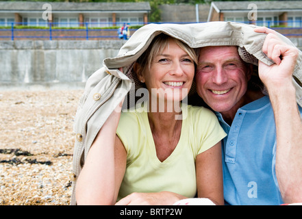 Seniors riparo sotto rivestimento sulla spiaggia Foto Stock