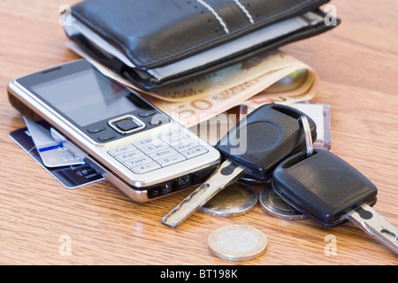 Mans wallet, cambiare il telefono e le chiavi dell'auto sul tavolo Foto Stock