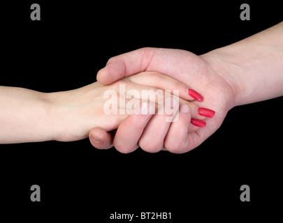 Mano nella mano su sfondo nero Foto Stock