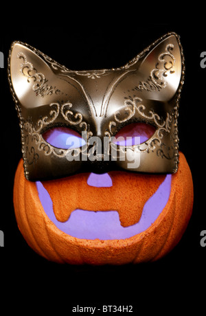 Zucca di Halloween indossando maschera masquerade isolato di esclusione di studio Foto Stock