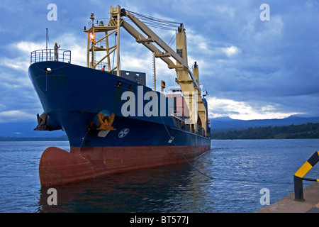 Olio di Luba Freeport. Nave container che arrivano al porto molo al tramonto prima del caricamento di carico dei contenitori Foto Stock