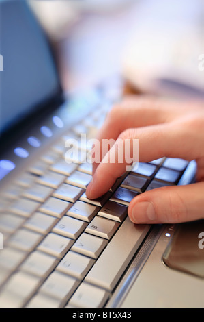 Macro vista ravvicinata dell uomo al lavoro sul corpo portatile parte solo a mano sulla tastiera del computer digitando il calettamento di messa a fuoco selettiva. Spazio di copia Foto Stock