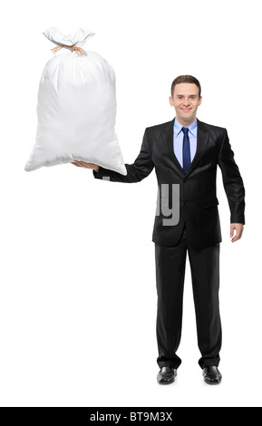 A piena lunghezza Ritratto di un happy businessman tenendo un sacco di denaro Foto Stock