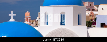 Tipica architettura con cupole della chiesa e torre campanaria Oia Santorini Cicladi Grecia Foto Stock