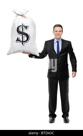 A piena lunghezza Ritratto di un happy businessman tenendo un sacchetto con US dollar sign Foto Stock