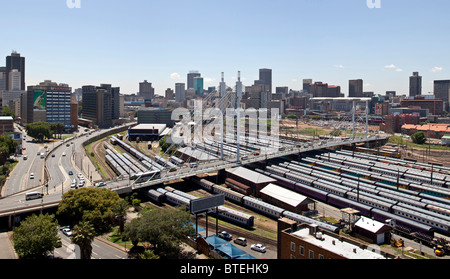 Il Nelson Mandela ponte sopra il Park Street Stazione ferroviaria con la skyline di Johannesburg in background Foto Stock
