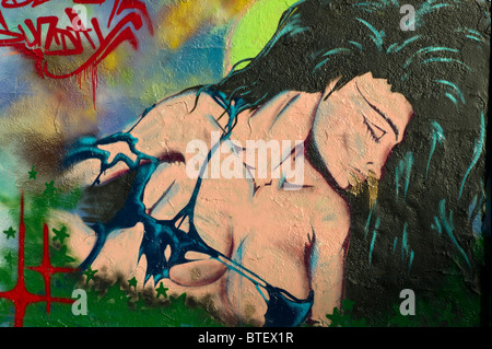 Graffiti / graffito che mostra un ritratto di una donna con lunghi capelli neri vestito vestito in un bikini top, Monaco di Baviera, Germania Foto Stock