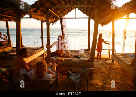 Surfers seduto a un ristorante e un bar sulla spiaggia in Colombo, Sri Lanka. Foto Stock