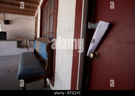 Censimento 2010 forma arrotolata e incuneato contro la porta di nob bloccato la porta anteriore del ranch house in West Texas Foto Stock