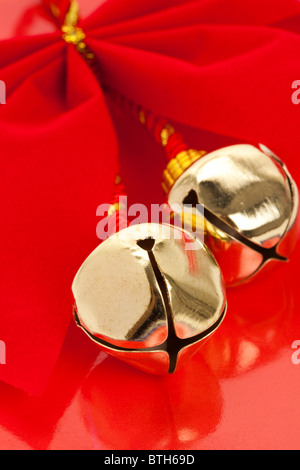 Natale campane e nastro con sfondo rosso Foto Stock