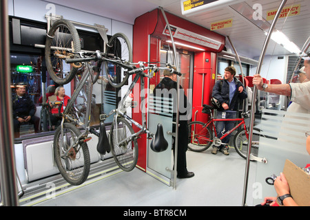 Mattina commuter porta la sua bicicletta sul bordo di un commuter rail auto in Austin, Texas Foto Stock