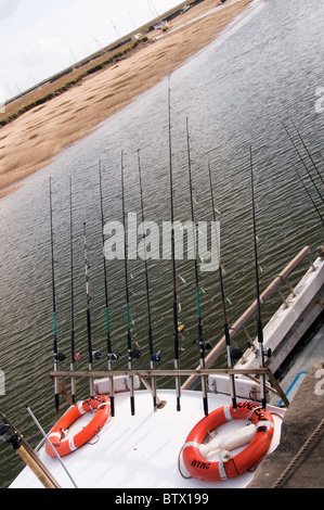 Canne da pesca su una barca da pesca pozzetti accanto il mare Norfolk England Regno Unito Foto Stock