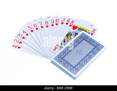 Giocattoli, giochi, giocando a carte, carte in tuta di cuori aperti a ventaglio in ordine numerico con il rimanente mazzo a faccia in giù Foto Stock