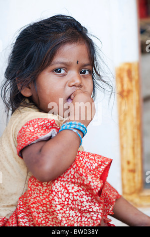 Indiano piccolo villaggio rurale ragazza mangia stracci palla per colazione, alla porta di casa sua. Andhra Pradesh, India Foto Stock