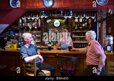 Bar proprietario, Grainne, con due locali nel suo bar in Timoleague, County Cork, Irlanda Foto Stock