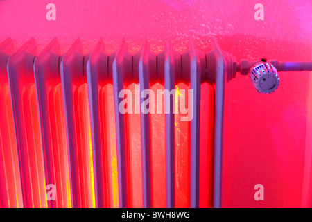 Radiatore illuminato, termostato riscaldamento centrale in una casa privata. Simbolo dell'immagine. Foto Stock