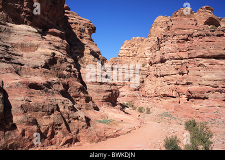 Petra gulch roccia cliff pareti rossastre scenario desertico Giordania Medio Oriente Foto Stock