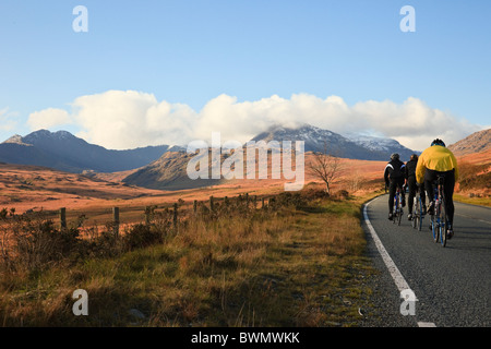 Gruppo di ciclisti in bicicletta lungo una strada di campagna attraverso Nantygwryd verso Snowdon Horseshoe nel Parco Nazionale di Snowdonia. Capel Curig, Galles del Nord, Regno Unito Foto Stock