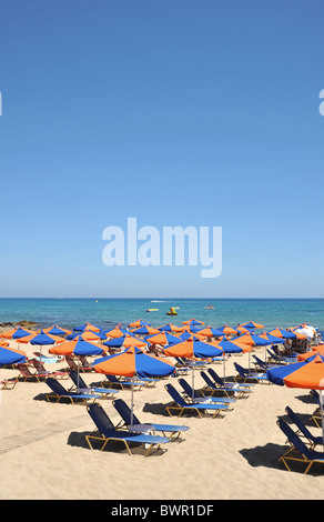 Bed sedie e ombrelloni sulla spiaggia. Questa immagine è stata scattata a Stalis o Stalida in Creta, Grecia Foto Stock