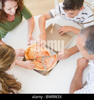 Famiglia di origine ispanica mangiare la pizza insieme Foto Stock