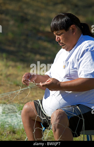 Yakama nazione indiana la riparazione di reti da pesca a Celilo villaggio sul fiume Columbia, Oregon, Stati Uniti d'America. Foto Stock