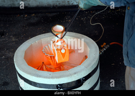 Fare ceramica Raku utilizzando un tradizionale riservato di cottura in ceramica Foto Stock