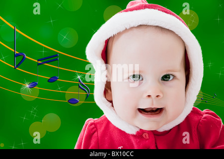 Baby a cantare i canti natalizi Foto Stock