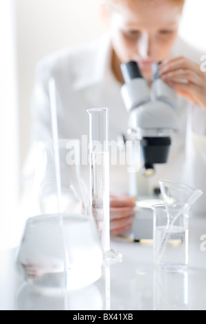 Laboratorio di microscopio - donna ricerca medica farmacia esperimento, bassa profondità di campo Foto Stock