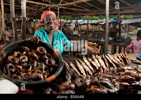 La sig.ra Annie Walker vende pesce nel mercato di Monrovia, Liberia dopo aver ricevuto un prestito di microfinanza. Foto Stock