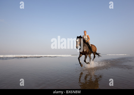 Equitazione presso il beach, la spiaggia di Kuta Beach, Bali, Indonesia, Asia sud-orientale, Asia Foto Stock
