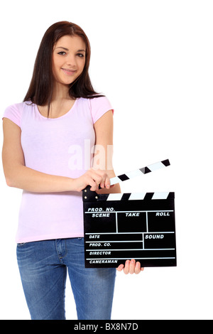 Attraente ragazza adolescente holding clapperboard. Tutto su sfondo bianco. Foto Stock