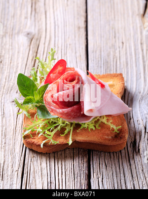 Prosciutti e salami su pane tostato Foto Stock