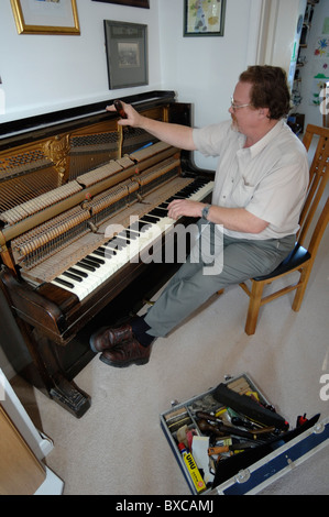 Sintonizzazione di un pianoforte verticale su una casa privata Foto Stock