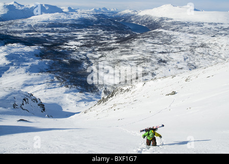 Un maschio di telemark sciatore escursionismo su una ripida couloir vicino a Narvik, Norvegia. Foto Stock