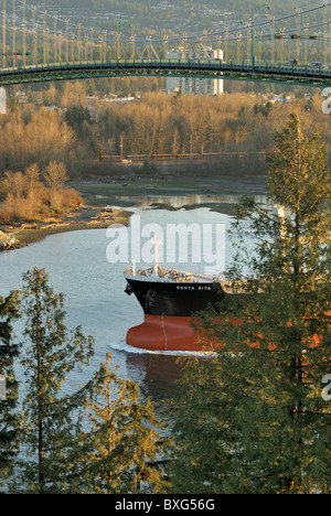 Prua del cargo Santa Rita sotto il Ponte Lions Gate uscire all interno del porto di Vancouver, all' inizio dell' autunno mattina. Foto Stock